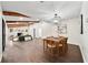 Open-concept living room with exposed wooden beams, stone fireplace, and hardwood floors at 1523 N Beach St, Ormond Beach, FL 32174