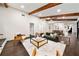 Stylish living room with wood beams, stone fireplace, and hardwood floors, open to dining at 1523 N Beach St, Ormond Beach, FL 32174