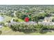 Aerial view of yellow townhomes with mature trees, parking, and green spaces, offering a serene community atmosphere at 1534 Barking Deer Cv, Casselberry, FL 32707