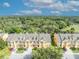 Aerial view of townhomes showcasing lush greenery and a serene neighborhood setting, offering a tranquil living environment at 1534 Barking Deer Cv, Casselberry, FL 32707