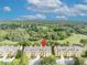 Charming townhome community, marked by a red pin, amidst lush trees and clear blue skies at 1534 Barking Deer Cv, Casselberry, FL 32707