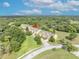 Aerial view showcases townhomes near lush green areas, mature trees, and landscaped surroundings, emphasizing the community's serene setting at 1534 Barking Deer Cv, Casselberry, FL 32707