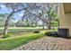 Spacious backyard with lush lawn, mature trees and brick patio, perfect for outdoor living at 1534 Barking Deer Cv, Casselberry, FL 32707