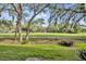 Expansive backyard featuring mature trees, lush lawn and ample space for outdoor activities at 1534 Barking Deer Cv, Casselberry, FL 32707