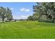 Expansive backyard with manicured lawn and mature trees, creating a peaceful outdoor space at 1534 Barking Deer Cv, Casselberry, FL 32707