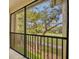 Screened-in balcony with a view of lush greenery and well-maintained landscaping at 1534 Barking Deer Cv, Casselberry, FL 32707