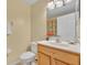 Well-lit bathroom with a single sink vanity, a toilet, and a neutral color scheme at 1534 Barking Deer Cv, Casselberry, FL 32707