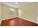Simple bedroom featuring hardwood floors, a bright window, and neutral wall color at 1534 Barking Deer Cv, Casselberry, FL 32707