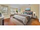 Bright bedroom featuring hardwood floors, a large bed with stylish linens, and plenty of natural light at 1534 Barking Deer Cv, Casselberry, FL 32707
