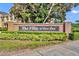 Elegant brick entrance sign for 'The Villas at Deer Run' with mature landscaping, creating a welcoming first impression at 1534 Barking Deer Cv, Casselberry, FL 32707