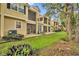 Exterior view of townhomes showcasing screened lanais, patios, and well-maintained lawns at 1534 Barking Deer Cv, Casselberry, FL 32707