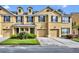 Charming townhome featuring a two-car garage, manicured lawn, and traditional architectural design at 1534 Barking Deer Cv, Casselberry, FL 32707