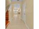 Bright foyer featuring tile flooring that transitions into an open layout with a staircase at 1534 Barking Deer Cv, Casselberry, FL 32707