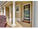 Inviting front porch with decorative wreath, supporting columns, and blooming shrubbery at 1534 Barking Deer Cv, Casselberry, FL 32707