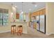 Eat-in kitchen featuring stainless steel appliances, wood cabinetry, and barstool seating at 1534 Barking Deer Cv, Casselberry, FL 32707