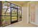 Screened lanai offering a serene view of lush backyard and access to the exterior at 1534 Barking Deer Cv, Casselberry, FL 32707