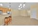 Open-concept living and kitchen area with tile floors and ample natural light at 1534 Barking Deer Cv, Casselberry, FL 32707