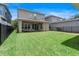 Large, grassy backyard with a covered patio, perfect for outdoor entertaining at 15448 Murcott Blossom Blvd, Winter Garden, FL 34787