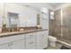 Modern bathroom with a tiled shower, granite counters and white cabinets at 15448 Murcott Blossom Blvd, Winter Garden, FL 34787