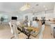 Open-concept dining area featuring a modern chandelier and stylish dining set at 15448 Murcott Blossom Blvd, Winter Garden, FL 34787
