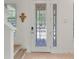 Entry foyer with a decorative glass door and staircase leading to the upper level at 15448 Murcott Blossom Blvd, Winter Garden, FL 34787