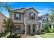 Beautiful two-story home with stone facade, charming shutters, and a well-maintained front yard at 15448 Murcott Blossom Blvd, Winter Garden, FL 34787