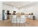 Bright kitchen features stainless steel appliances, granite countertops, and a convenient breakfast bar with bar stool seating at 15448 Murcott Blossom Blvd, Winter Garden, FL 34787