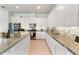 Modern kitchen with granite countertops, stainless steel appliances, tile backsplash and ample white cabinets at 15448 Murcott Blossom Blvd, Winter Garden, FL 34787