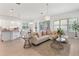 Open-concept living area featuring modern decor, a kitchen island, and seamless flow at 15448 Murcott Blossom Blvd, Winter Garden, FL 34787