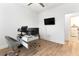 Modern home office featuring sleek desk, ergonomic chair, and a large screen monitor at 15448 Murcott Blossom Blvd, Winter Garden, FL 34787