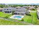 Aerial view of the backyard, with a pool, covered patio, fencing, and lush lawn at 16412 Good Hearth Blvd, Clermont, FL 34711