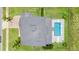 Stunning aerial view of a home with a private pool and lush landscaping at 16412 Good Hearth Blvd, Clermont, FL 34711