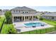 Stunning backyard featuring a modern pool, patio area, lush greenery, and a secure fence at 16412 Good Hearth Blvd, Clermont, FL 34711
