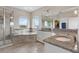 Well-appointed bathroom with a glass shower, soaking tub, and granite countertops at 16412 Good Hearth Blvd, Clermont, FL 34711