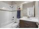 Well-lit bathroom featuring white tiled shower/tub combo and a modern vanity at 16412 Good Hearth Blvd, Clermont, FL 34711