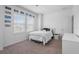 Bright bedroom with a large window, crisp white walls, a comfy bed and neutral carpet at 16412 Good Hearth Blvd, Clermont, FL 34711