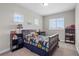 Cozy bedroom featuring a comfortable bed, carpeted floor, and two bright windows at 16412 Good Hearth Blvd, Clermont, FL 34711