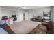 Large bonus room with comfortable seating, a desk, and ample space for entertainment at 16412 Good Hearth Blvd, Clermont, FL 34711
