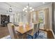 Bright dining room with a wood table, six chairs, and views from the large windows at 16412 Good Hearth Blvd, Clermont, FL 34711