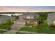 Stunning two-story home with a three-car garage, lush lawn, landscaping, and scenic water view at 16412 Good Hearth Blvd, Clermont, FL 34711