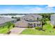 Beautiful two-story home with manicured lawn, lush landscaping, and 3-car garage at 16412 Good Hearth Blvd, Clermont, FL 34711