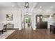 Hallway with beautiful hardwood floors leading to living spaces at 16412 Good Hearth Blvd, Clermont, FL 34711