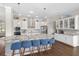 Gorgeous gourmet kitchen features white cabinetry, granite countertops and stainless appliances at 16412 Good Hearth Blvd, Clermont, FL 34711