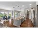 Open concept kitchen with large center island, stainless steel appliances, and hardwood flooring at 16412 Good Hearth Blvd, Clermont, FL 34711