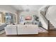 Bright and spacious living room featuring elegant decor and a staircase at 16412 Good Hearth Blvd, Clermont, FL 34711