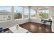Well-lit office space with large windows, hardwood floors, and a modern desk at 16412 Good Hearth Blvd, Clermont, FL 34711