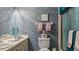 Bathroom featuring patterned wallpaper, white vanity, and a shower/tub with curtain at 165 Durham Pl # 165, Longwood, FL 32779