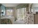 Bedroom with view to screened porch, light gray carpet, and bright natural light from windows and glass sliding door at 165 Durham Pl # 165, Longwood, FL 32779