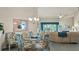 Open concept dining room with a glass-top table, elegant chandelier, and comfortable seating at 165 Durham Pl # 165, Longwood, FL 32779
