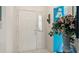 Warm and inviting entryway with tile floors, a white door, and a decorative floral arrangement at 165 Durham Pl # 165, Longwood, FL 32779